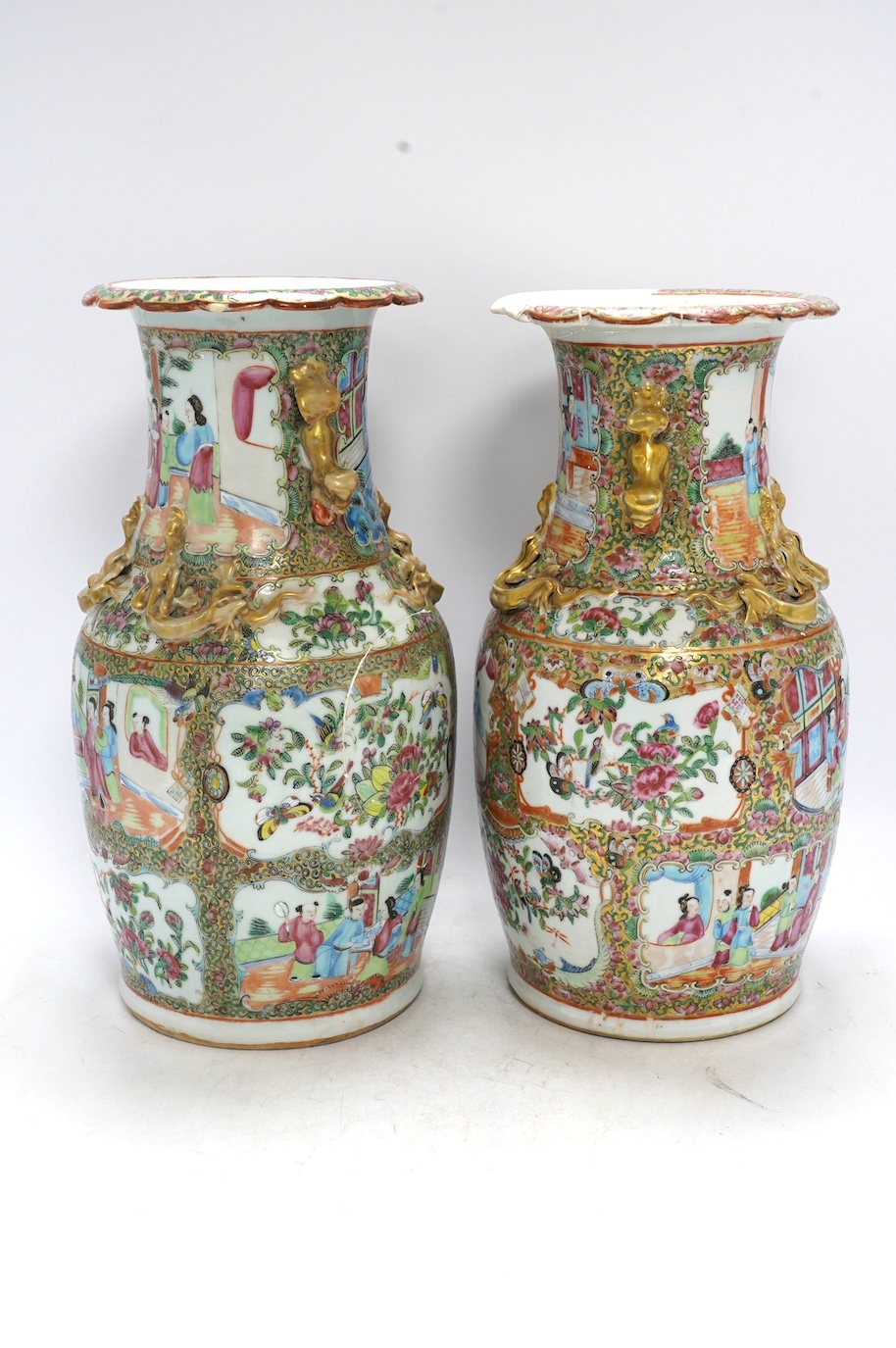 A pair of 19th century Chinese Canton famille rose vases, 36cm high. Condition - poor